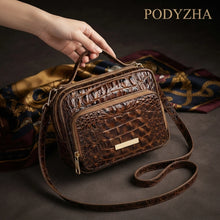 Light brown crocodile-embossed structured satchel with gold-tone hardware