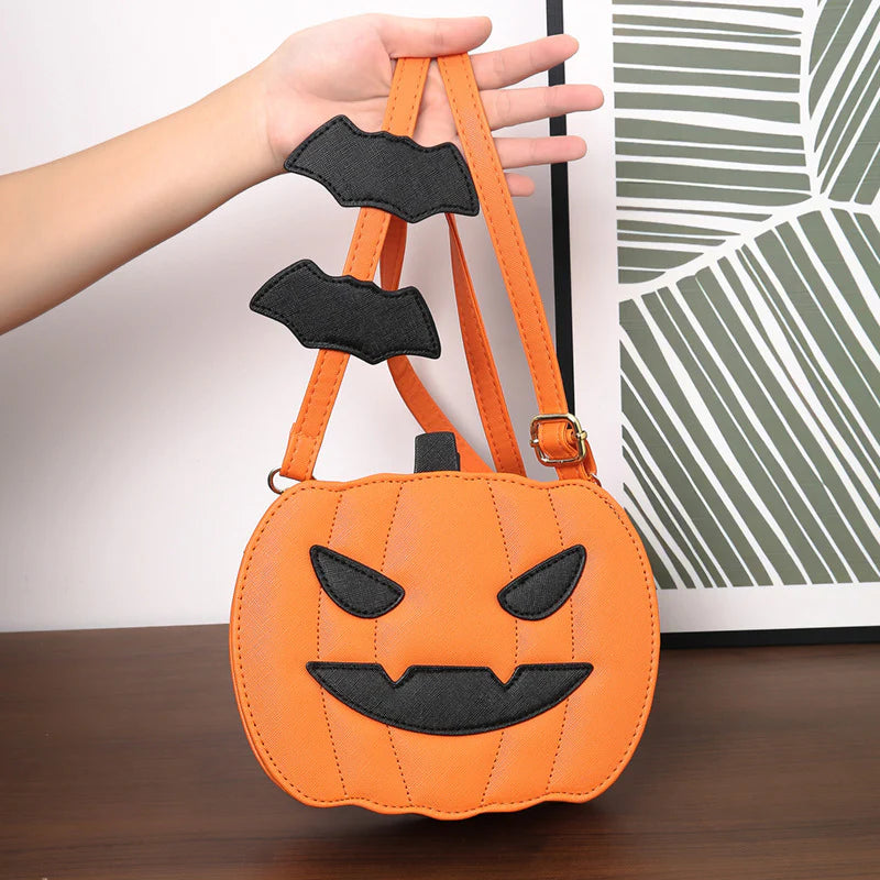 Orange pumpkin purse showing top closure and bat-detail strap
