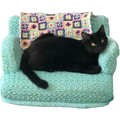 Couch Cat ornament showing a black cat on a mint sofa