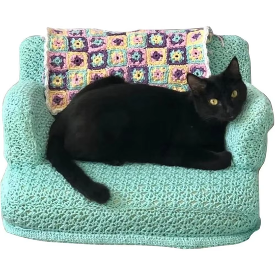 Couch Cat ornament showing a black cat on a mint sofa