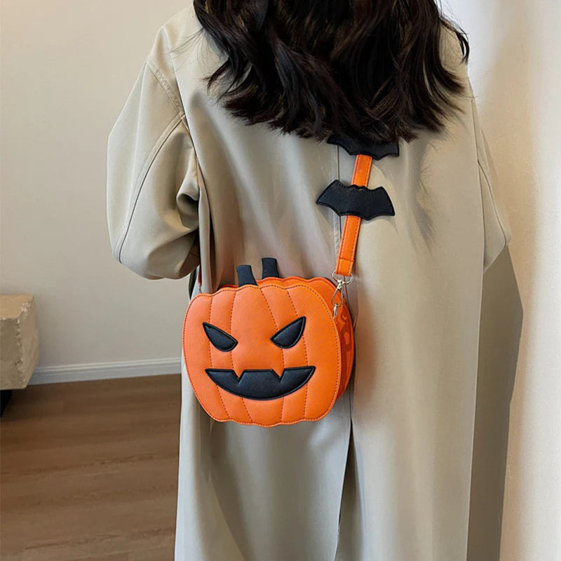 Spooky Orange pumpkin purse worn crossbody with bat-detail strap