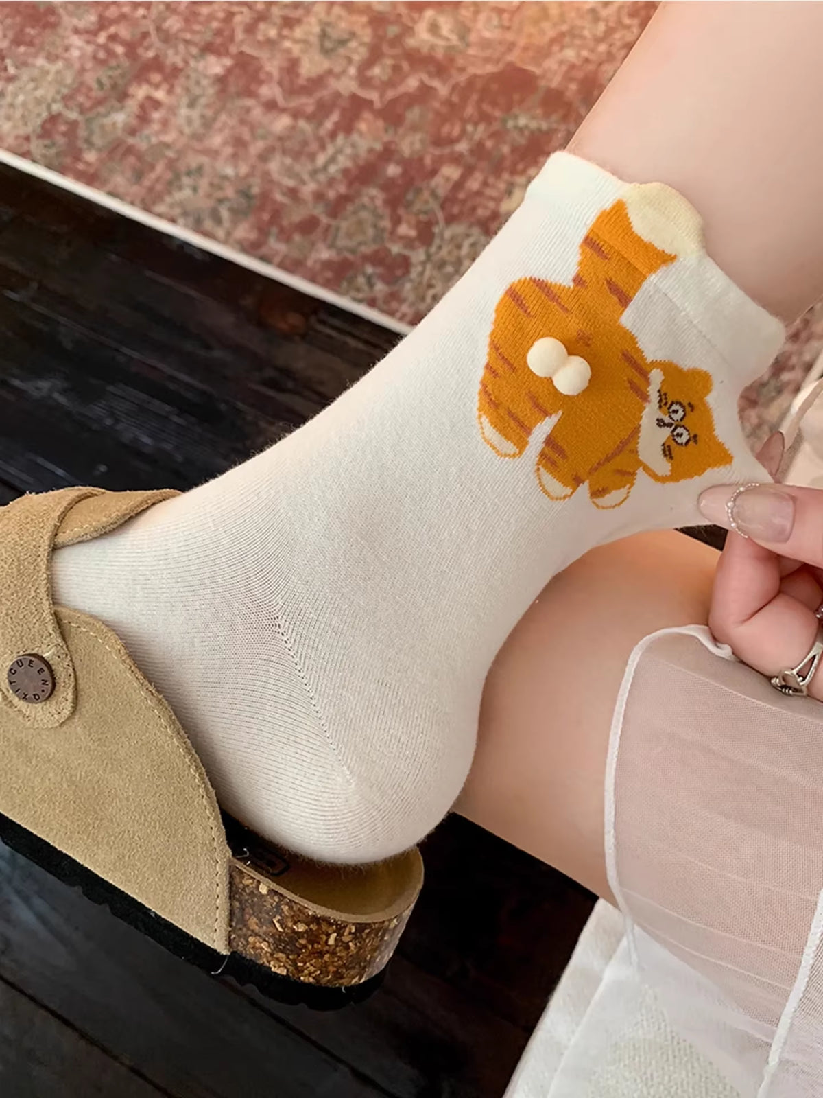 White cat socks with orange cat design