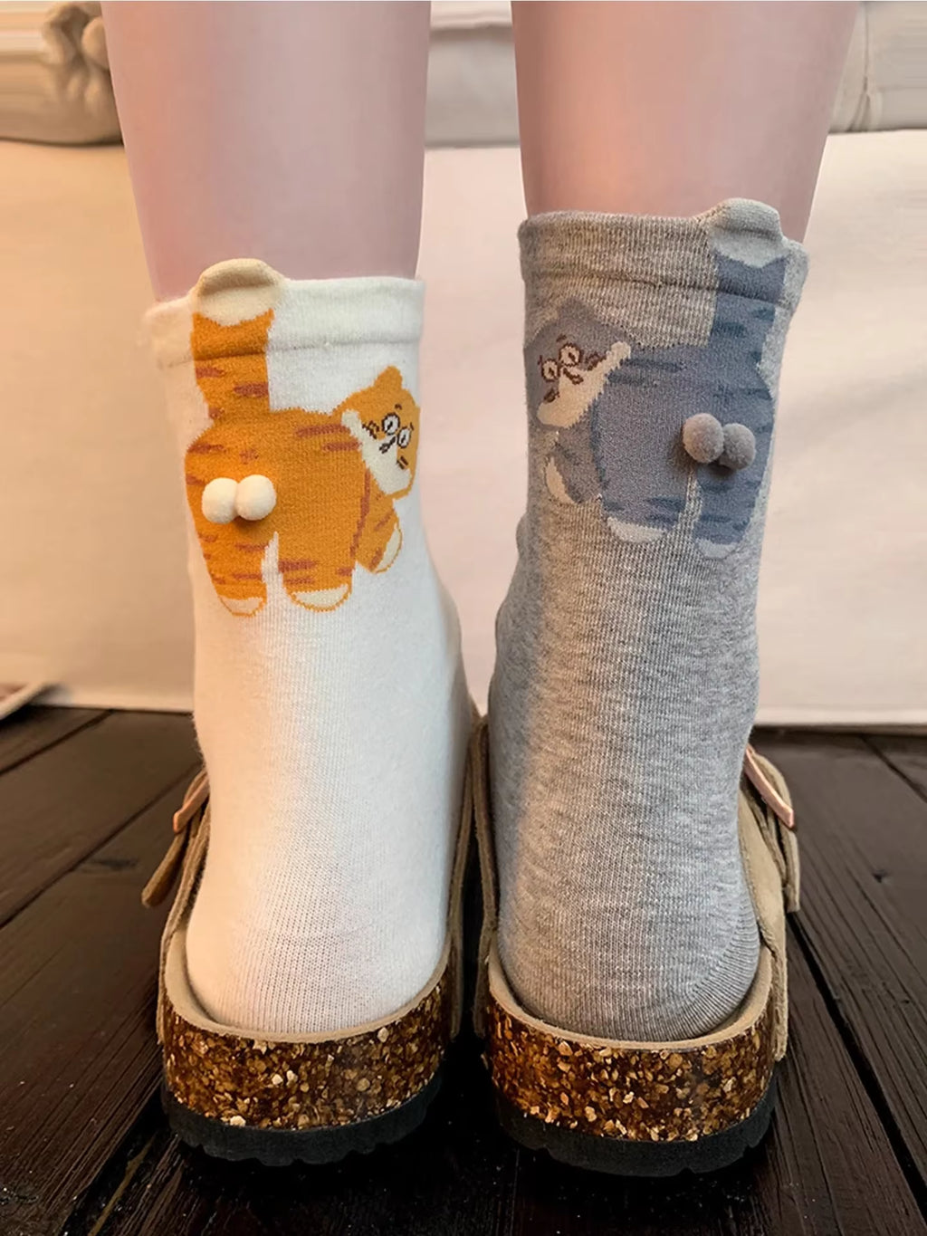 White and gray cat-pattern novelty socks shown together