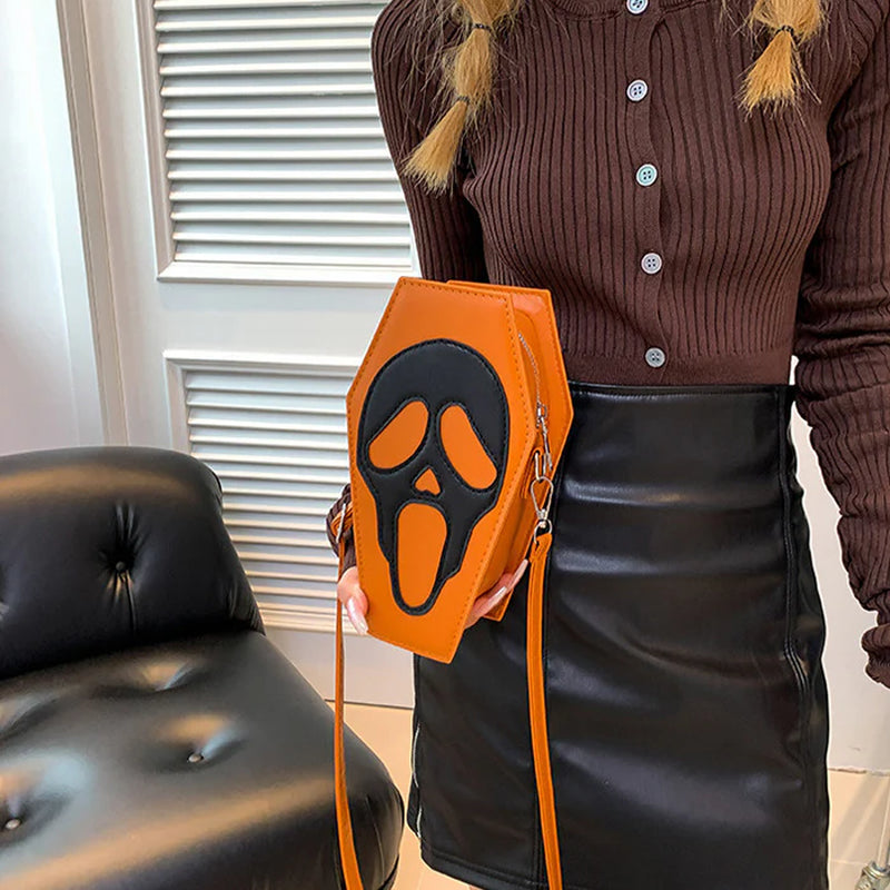 Brown skull-face coffin purse worn over the shoulder