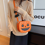 Happy Orange jack-o’-lantern purse worn over the shoulder
