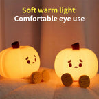 Two glowing pumpkin night lights illustrating the warm light