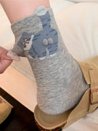Gray cat sock close-up with raised details