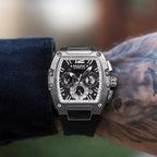 Close-up of the tonneau watch dial and black strap on a wrist