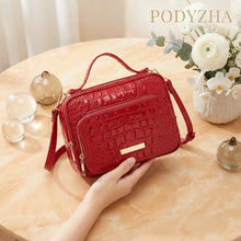 Red crocodile-embossed structured satchel with gold-tone hardware