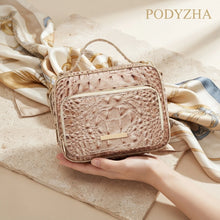 Beige crocodile-embossed structured satchel with gold-tone hardware