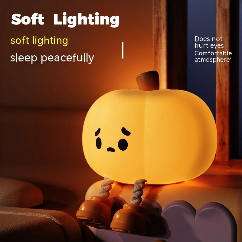 Pumpkin night light beside a bed with warm illumination