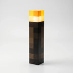 Block-style torch lamp standing upright on a white background