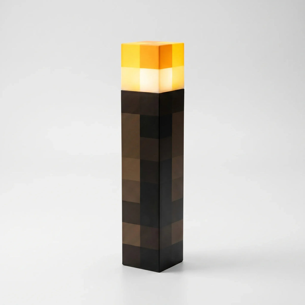 Block-style torch lamp standing upright on a white background