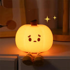 Warm pumpkin night light glowing beside a bed