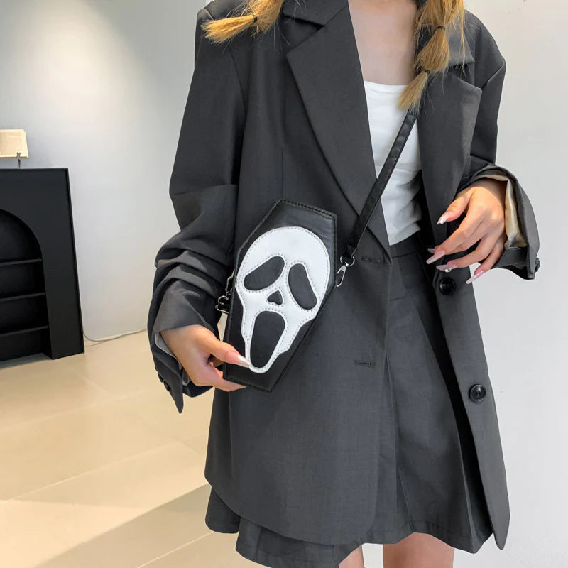 Black skull-face coffin purse styled with a dark outfit