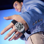 Model wearing the silver-tone tonneau watch with a blue shirt